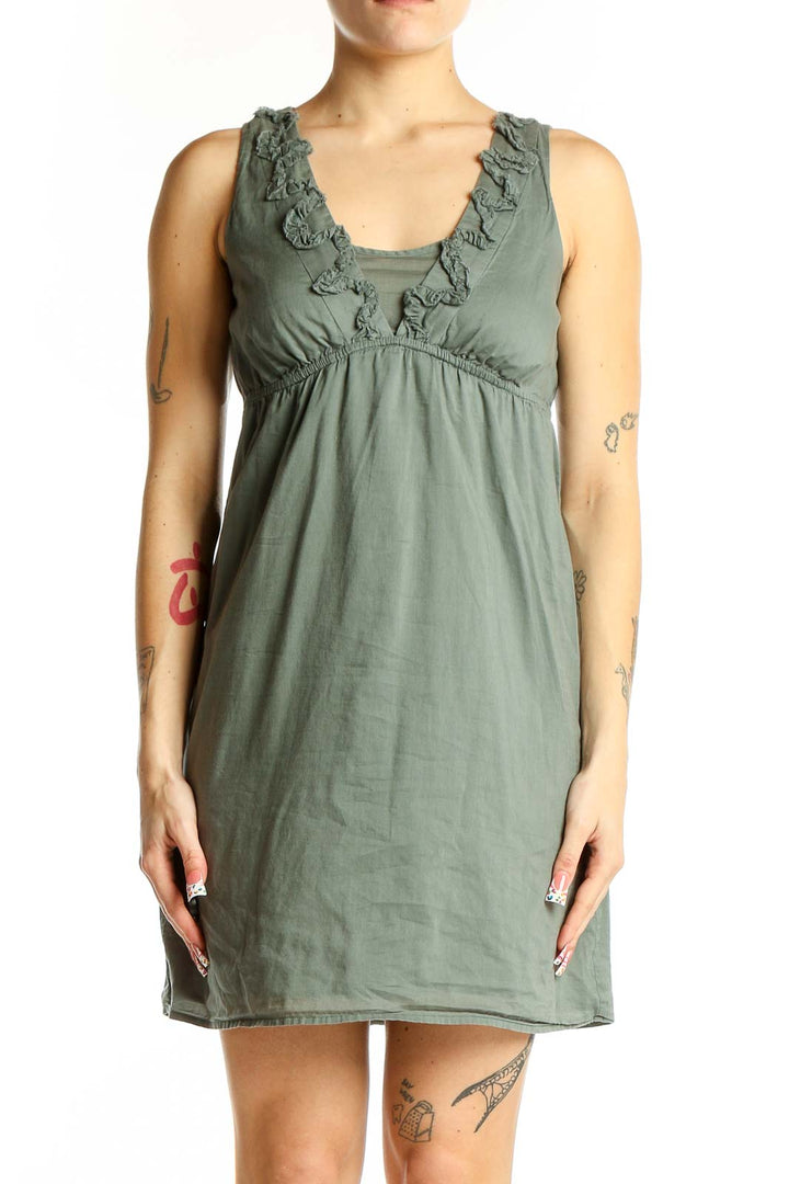 Front view of Ann Taylor LOFT sage green cotton dress with empire waist and ruffle neckline