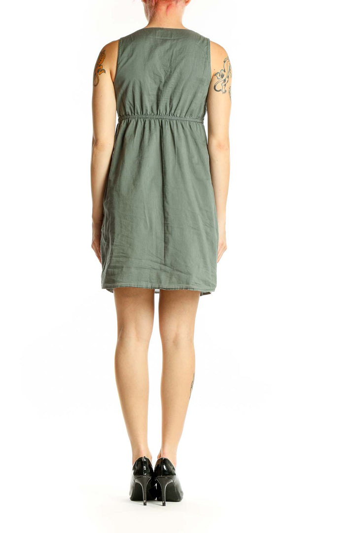 Side view of Ann Taylor LOFT sage green cotton dress showing knee-length cut