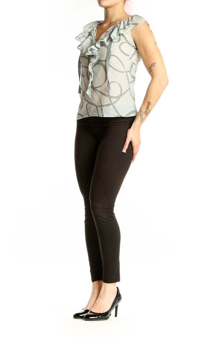 Front view of Ann Taylor LOFT light gray sleeveless blouse with ruffled V-neck and swirl pattern