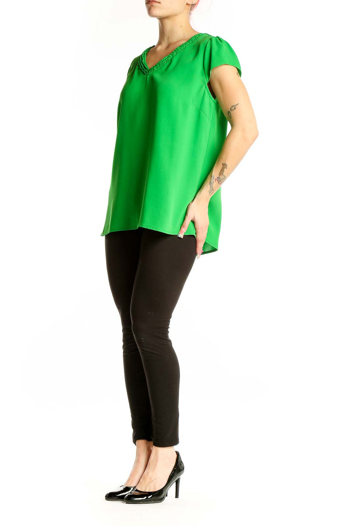 Front view of green V-neck cap sleeve blouse by Skies Are Blue