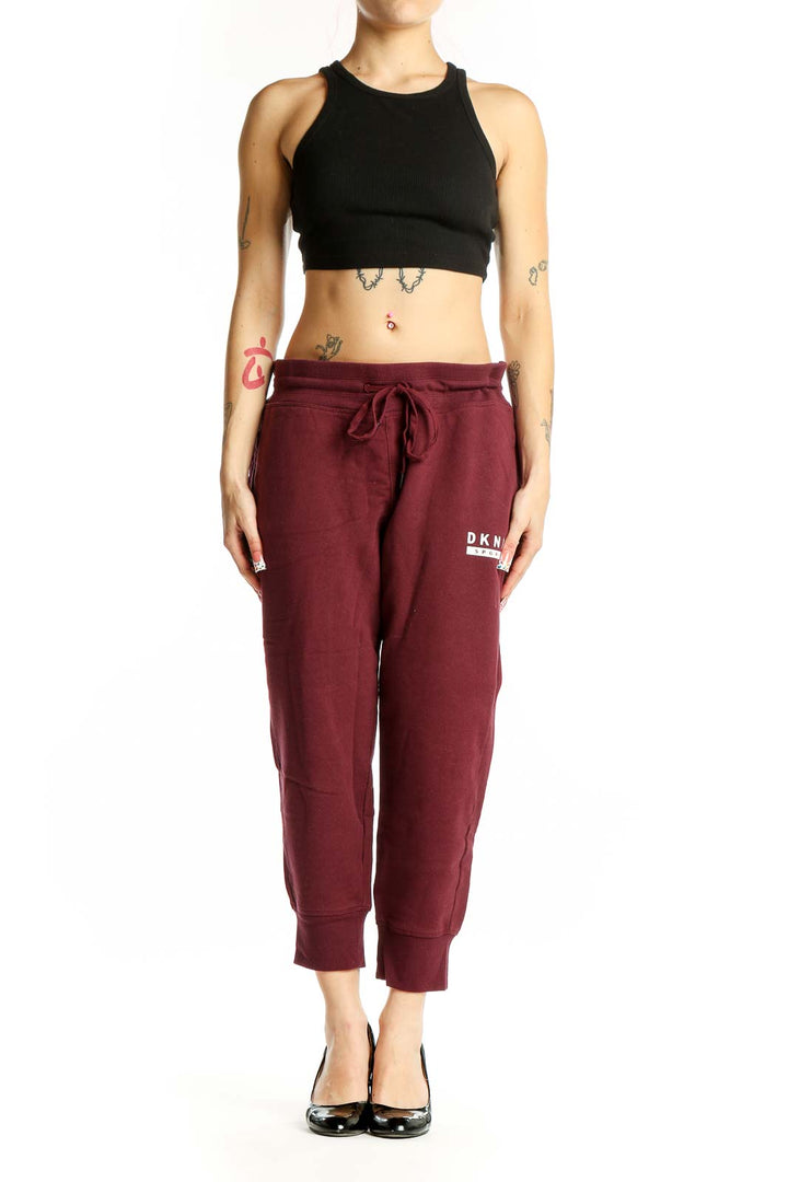 Front view of DKNY Sport burgundy cotton joggers with drawstring waist