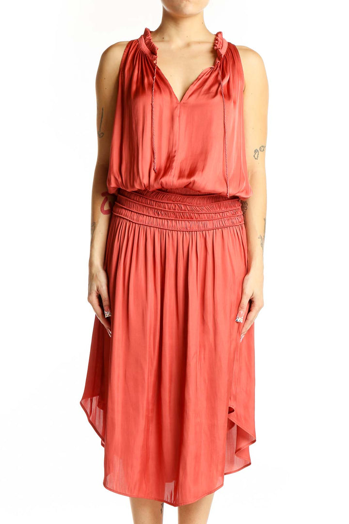 Front view of coral Eva Mendes midi dress with V-neck and ruffle details