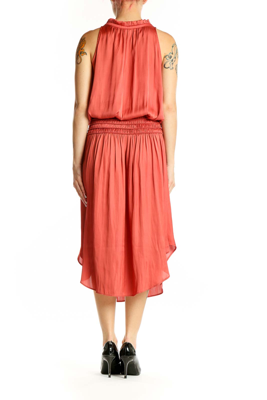 Side view of coral Eva Mendes midi dress showing asymmetrical hem and smocked waistband