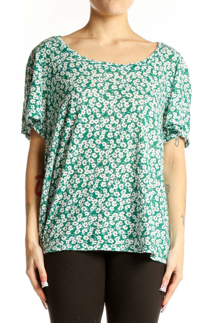 Front view of green floral print cotton top with short flutter sleeves