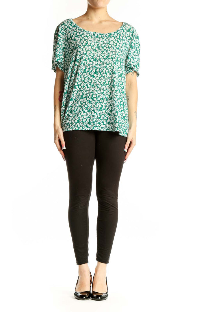 Front view of green floral print cotton top with short flutter sleeves