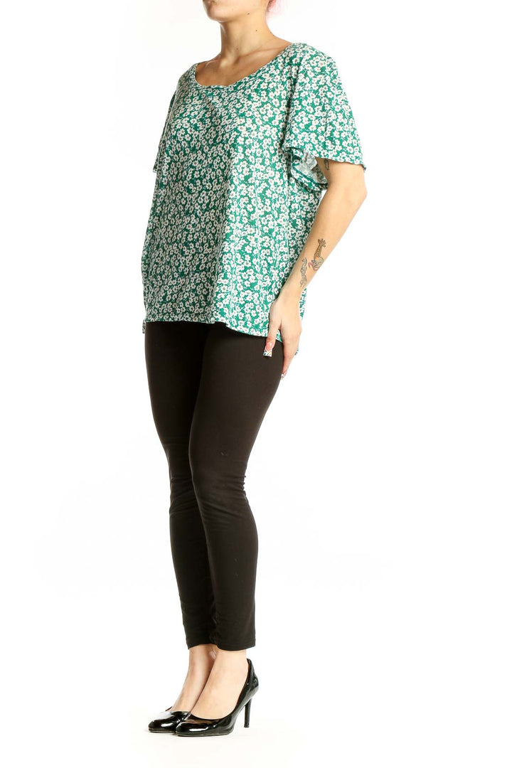 Front view of green floral print cotton top with short flutter sleeves