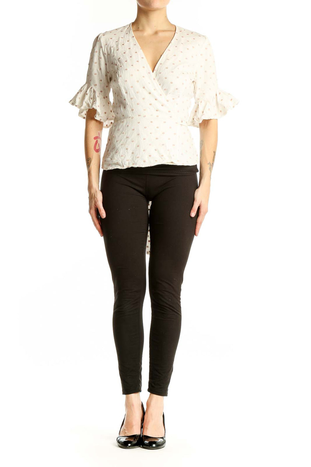 Front view of Wayf white polka dot wrap top with ruffle sleeves