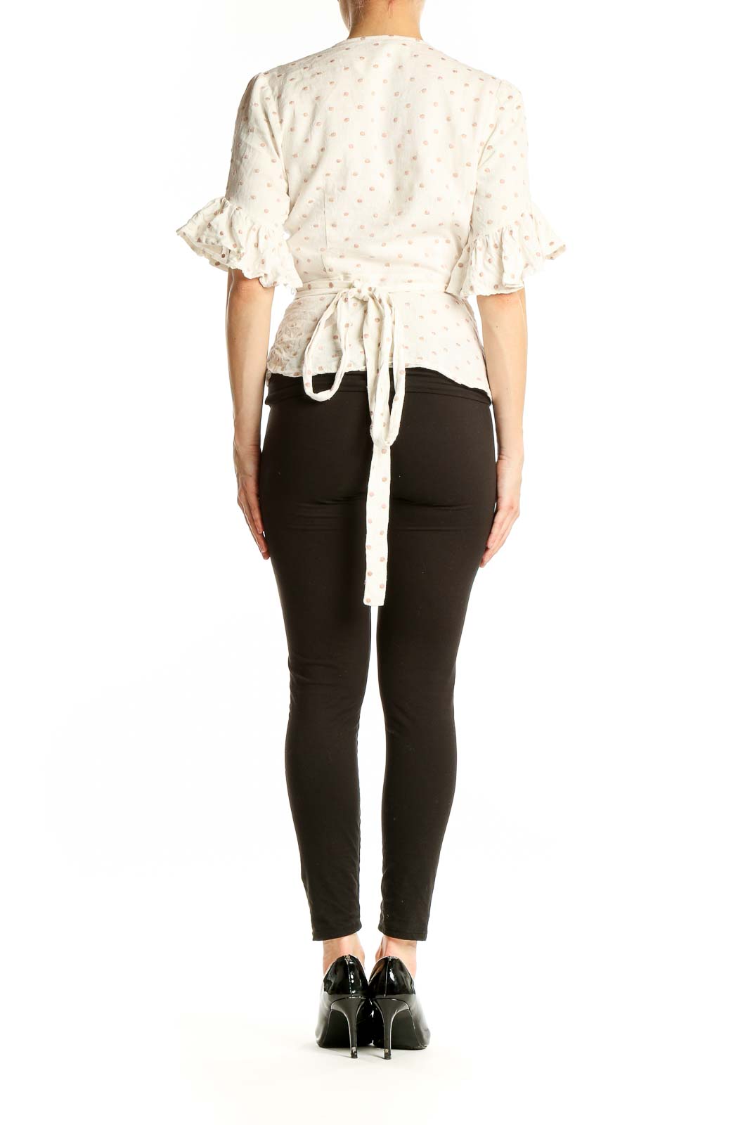 Back view of Wayf white polka dot wrap top showing fit and style