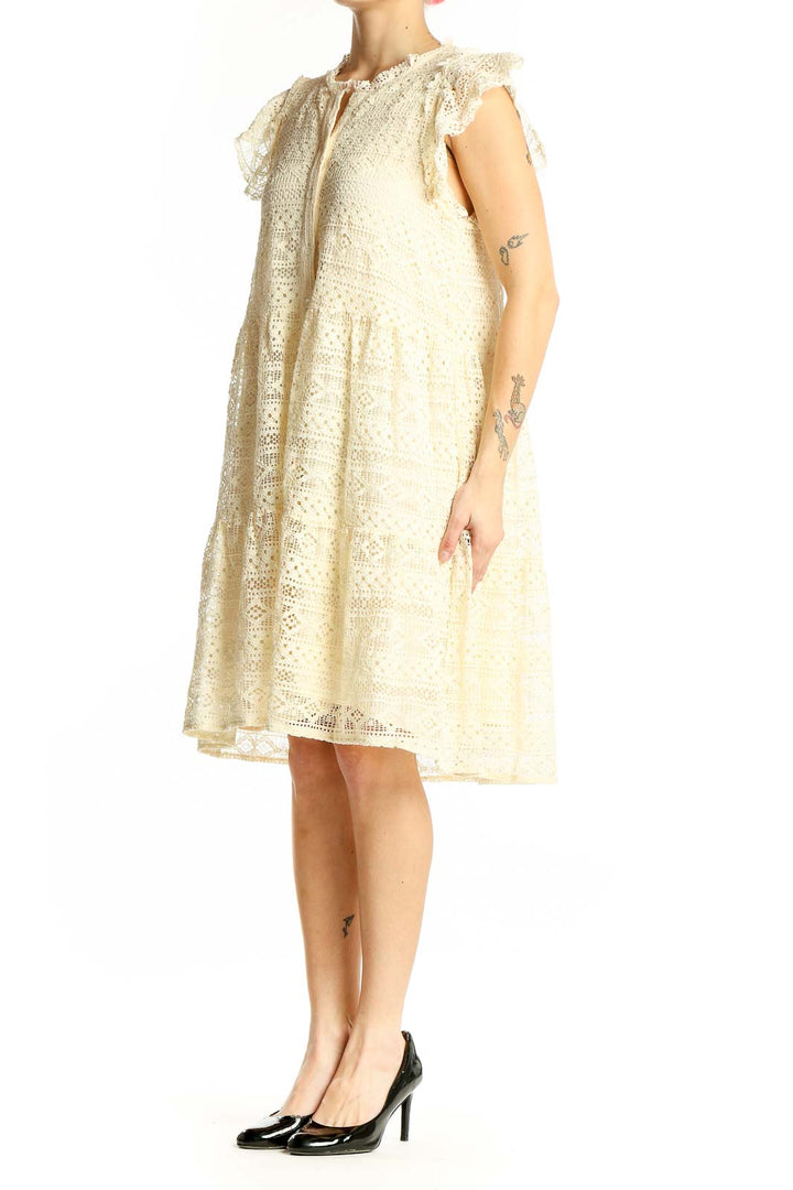 Front view of cream lace tiered midi dress with flutter sleeves