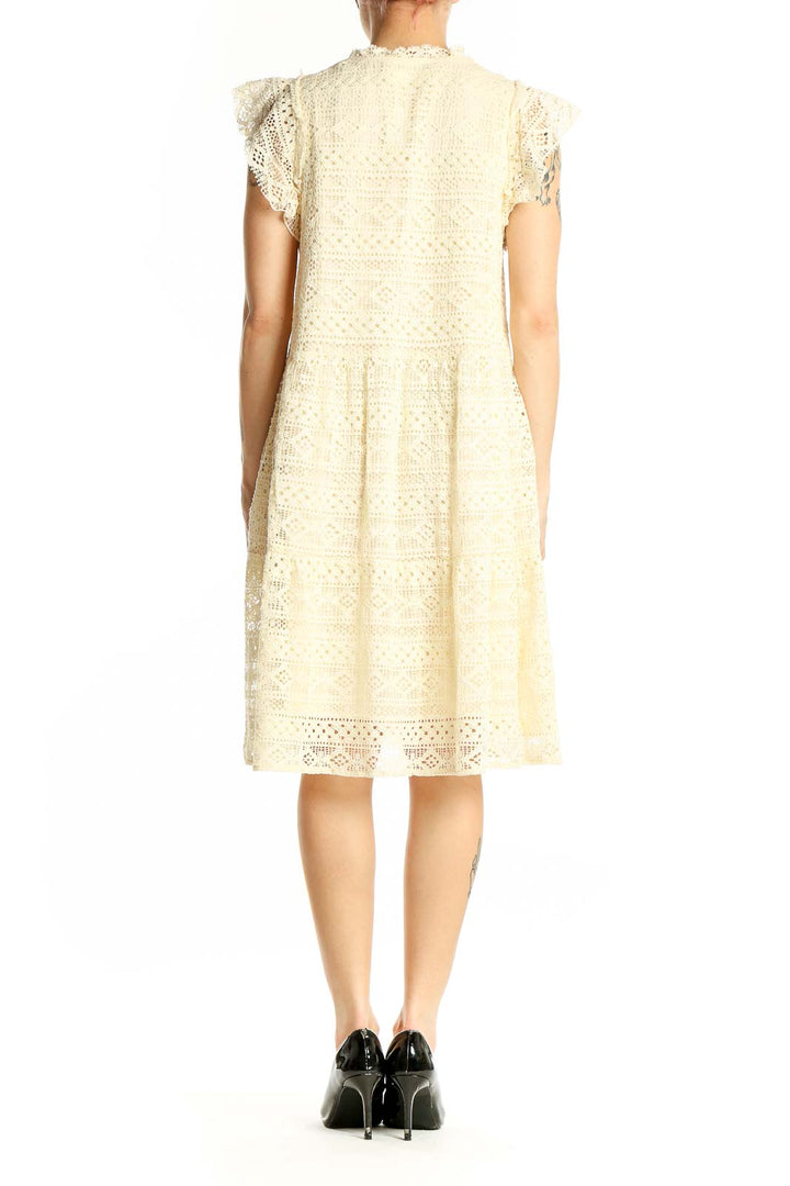 Back view of cream lace tiered midi dress showing full length and silhouette