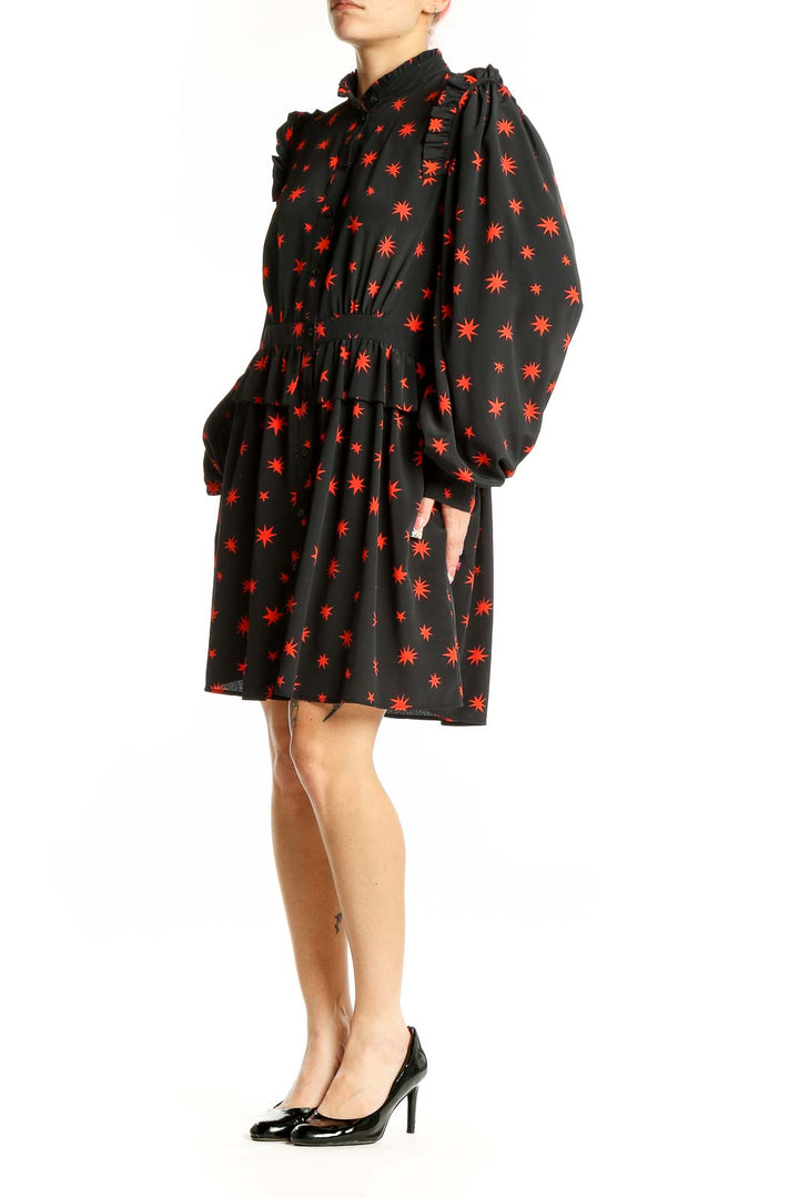 Front view of Topshop black mini dress with red star print and puff sleeves