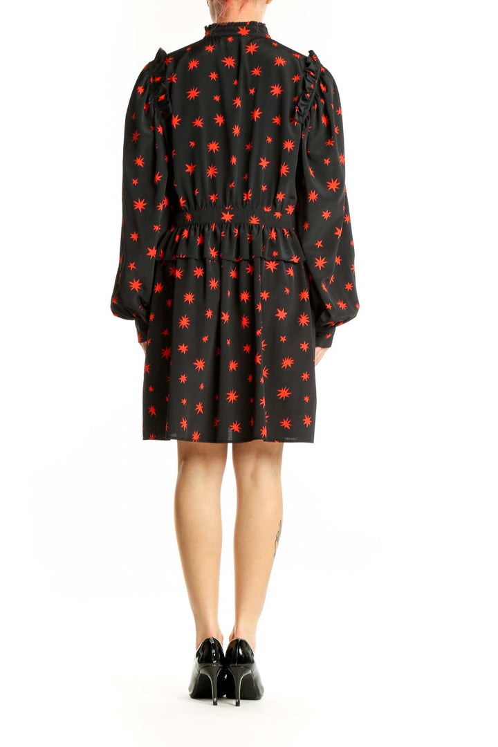 Side view of Topshop black mini dress showing star print and silhouette