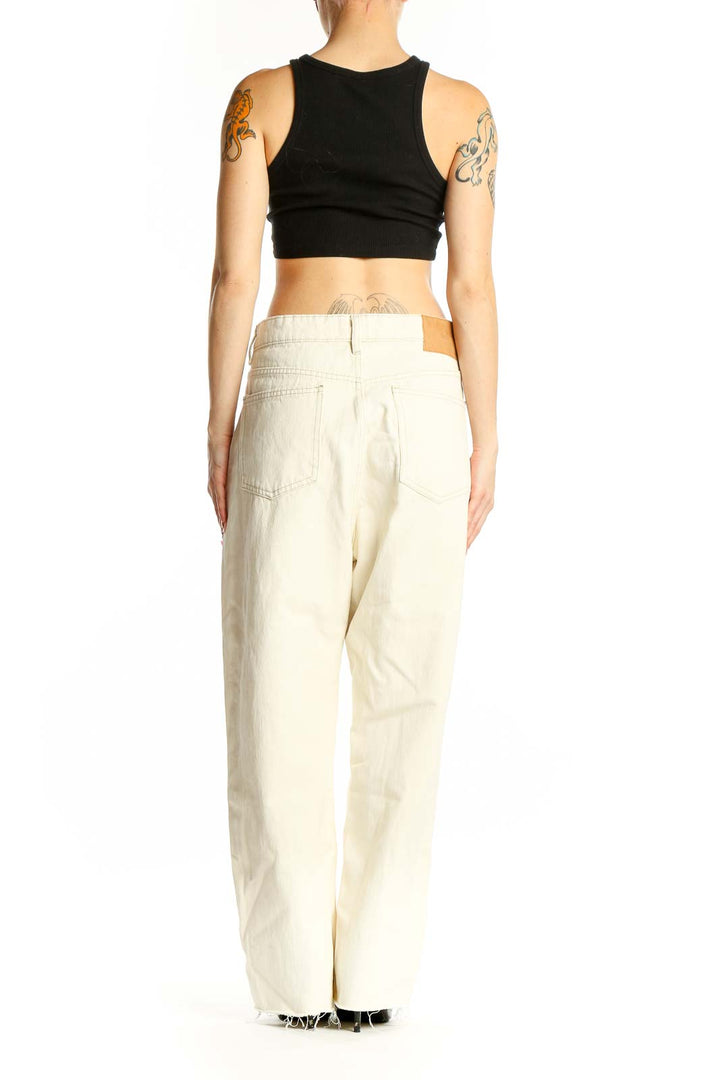 Side view of model wearing Zara cream wide-leg cotton denim jeans
