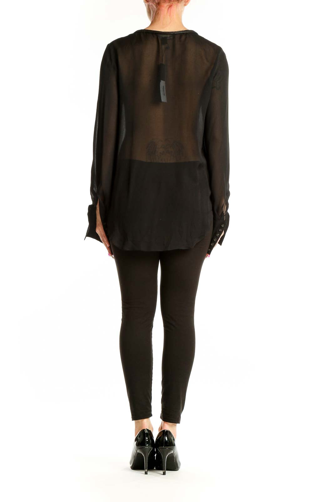 Full-length view of model wearing Elizabeth and James black sheer silk blouse