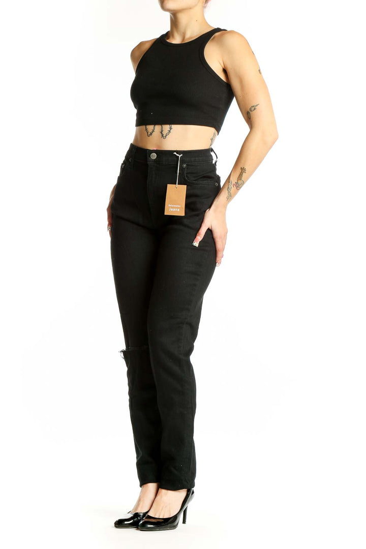 Front view of Reformation black high-waisted straight leg jeans with knee slit