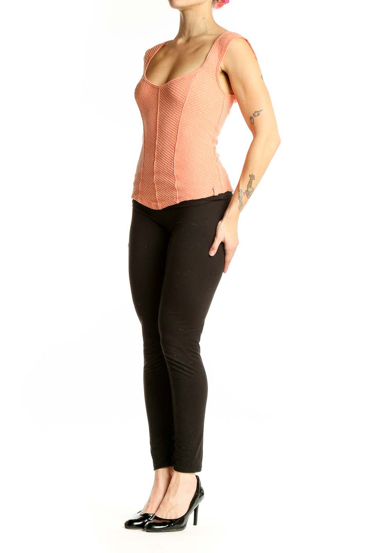 Front view of WE THE FREE peach textured sleeveless crop top