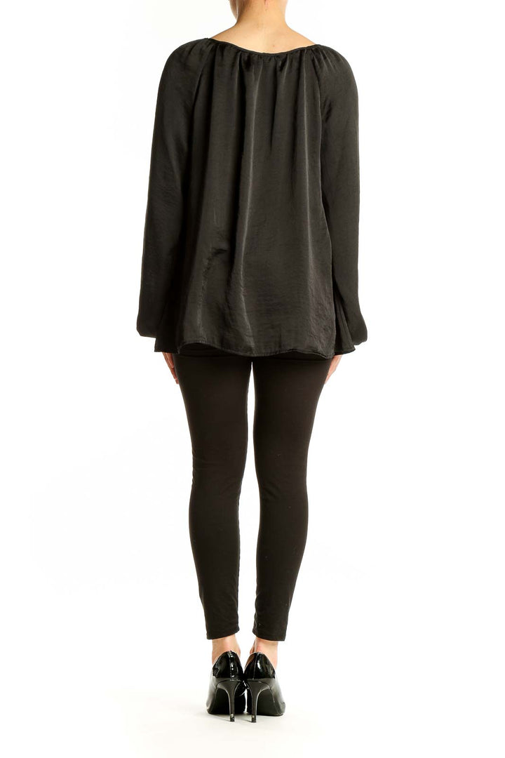 Back view of black peasant blouse showing flowy silhouette
