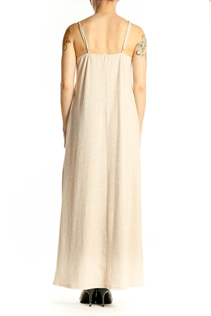Side view of beige ribbed maxi dress showing full length and fit