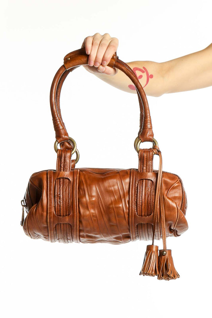 Front view of MARC JACOBS brown leather shoulder bag with tassel details