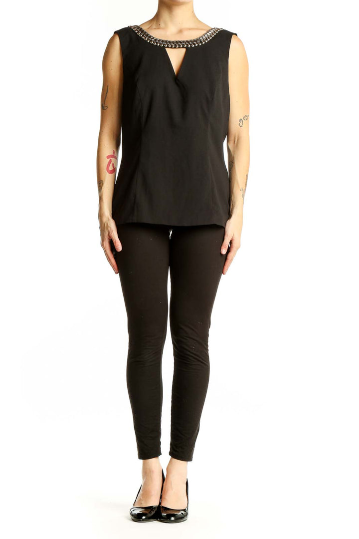 Front view of XOXO black sleeveless blouse with embellished neckline