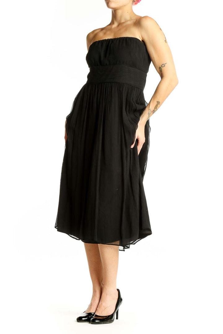 Front view of J.Crew black strapless midi dress with gathered bodice