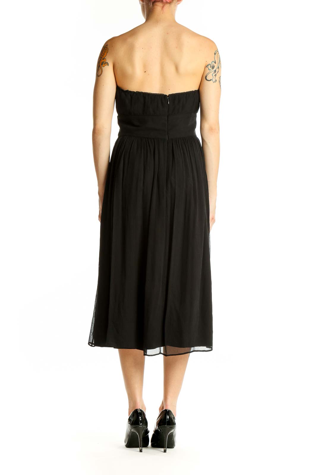 Side view of J.Crew black strapless midi dress showing flowy skirt