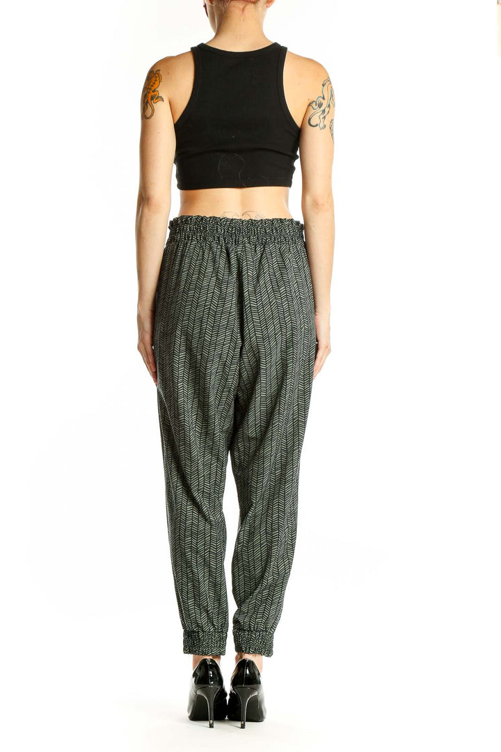 Side view of green herringbone Athleta jogger pants on model