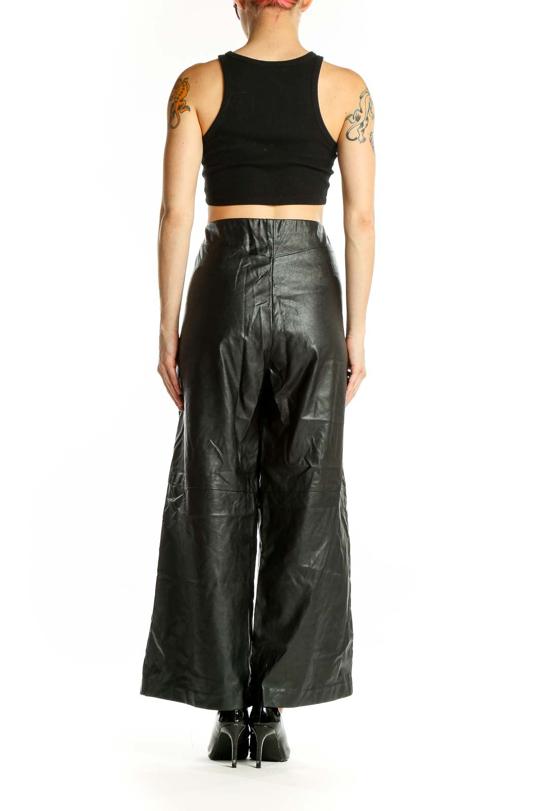 Side view of model wearing Karen Kane black faux-leather wide-leg pants
