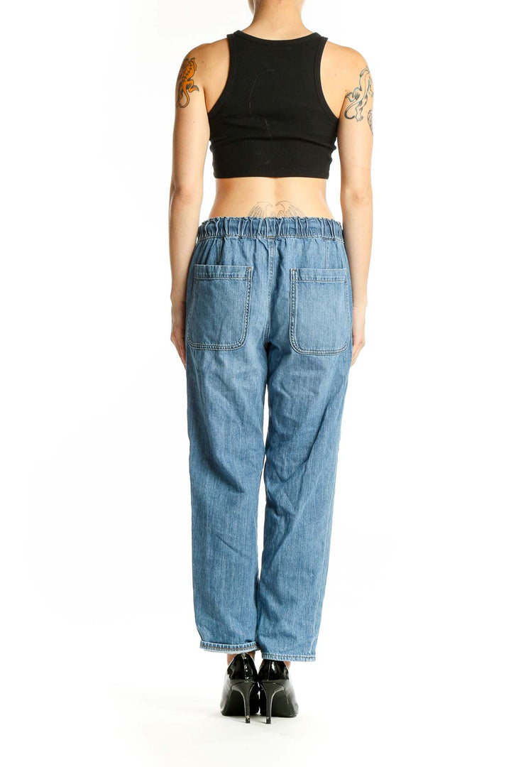Side view of model wearing J.Crew light blue denim pants with black top
