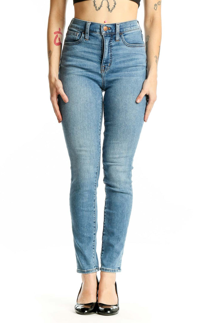 Front view of Madewell light blue high-waisted skinny jeans on model