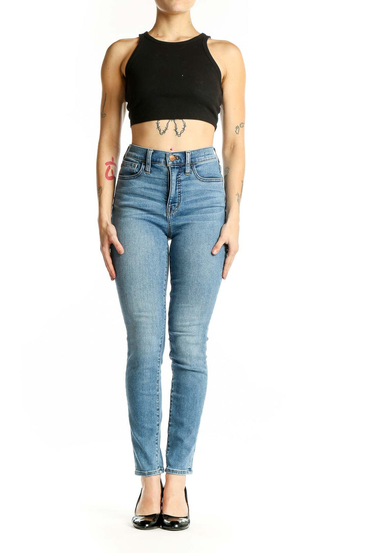 Front view of Madewell light blue high-waisted skinny jeans on model