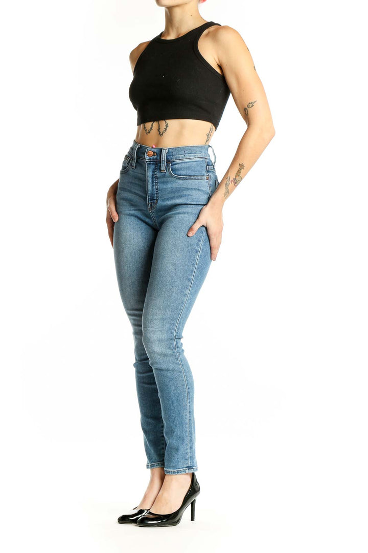 Front view of Madewell light blue high-waisted skinny jeans on model