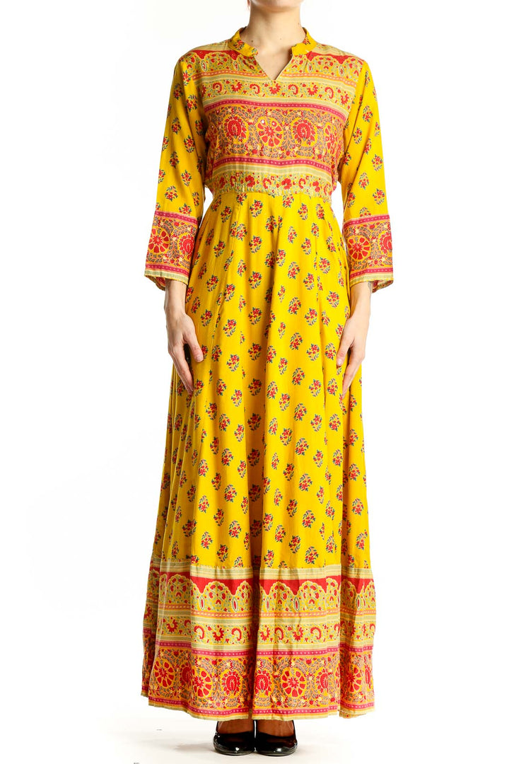 Front view of yellow floral maxi dress with empire waist and border prints
