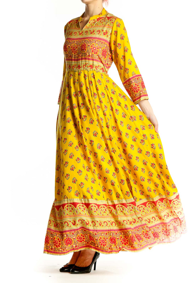 Front view of yellow floral maxi dress with empire waist and border prints