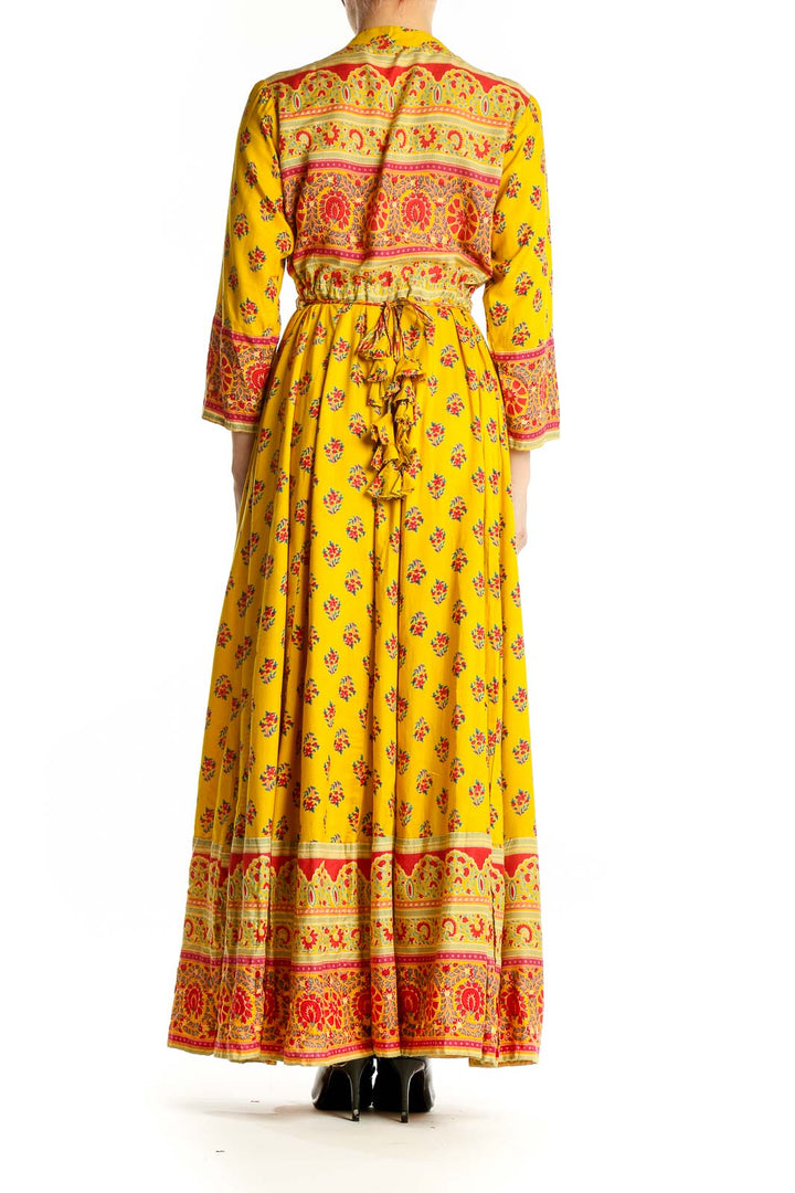 Back view of yellow floral maxi dress showing full length and pattern details