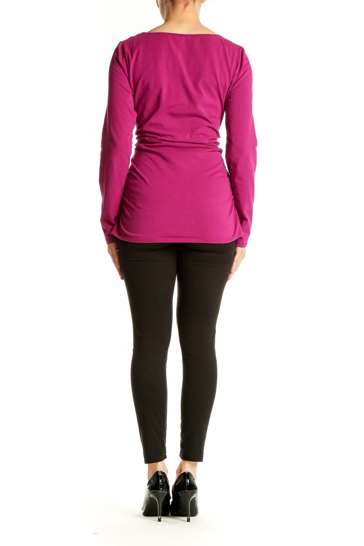 Side view of magenta Boston Proper top showing ruched detailing and long sleeves