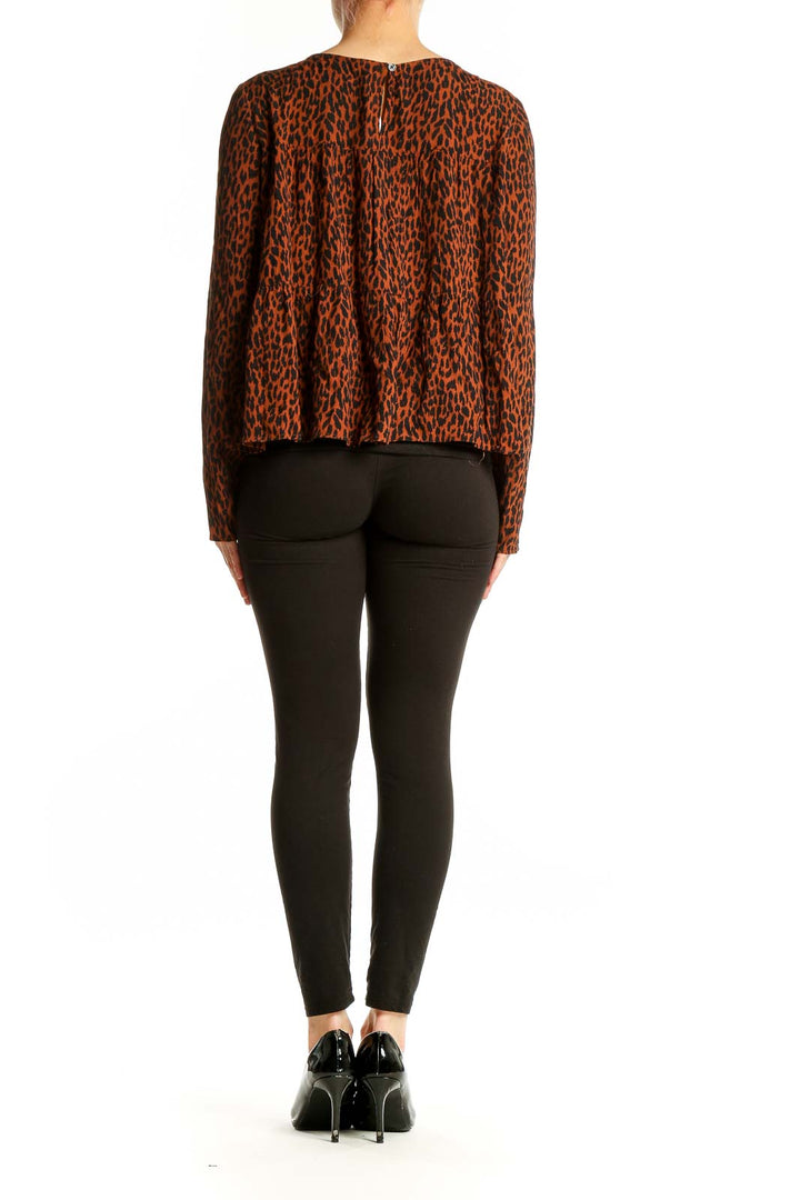 Back view of Gap rust leopard print flowy blouse on model