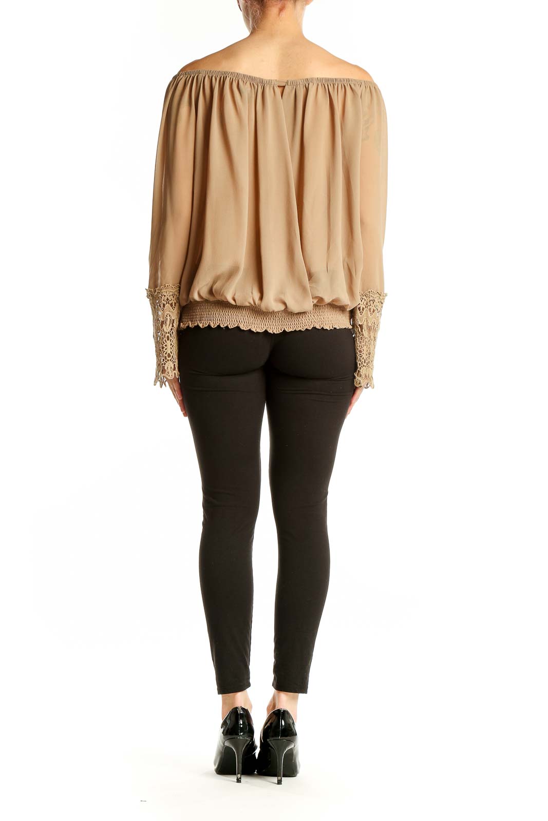 Side view of model wearing beige Umgee off-shoulder blouse with black pants