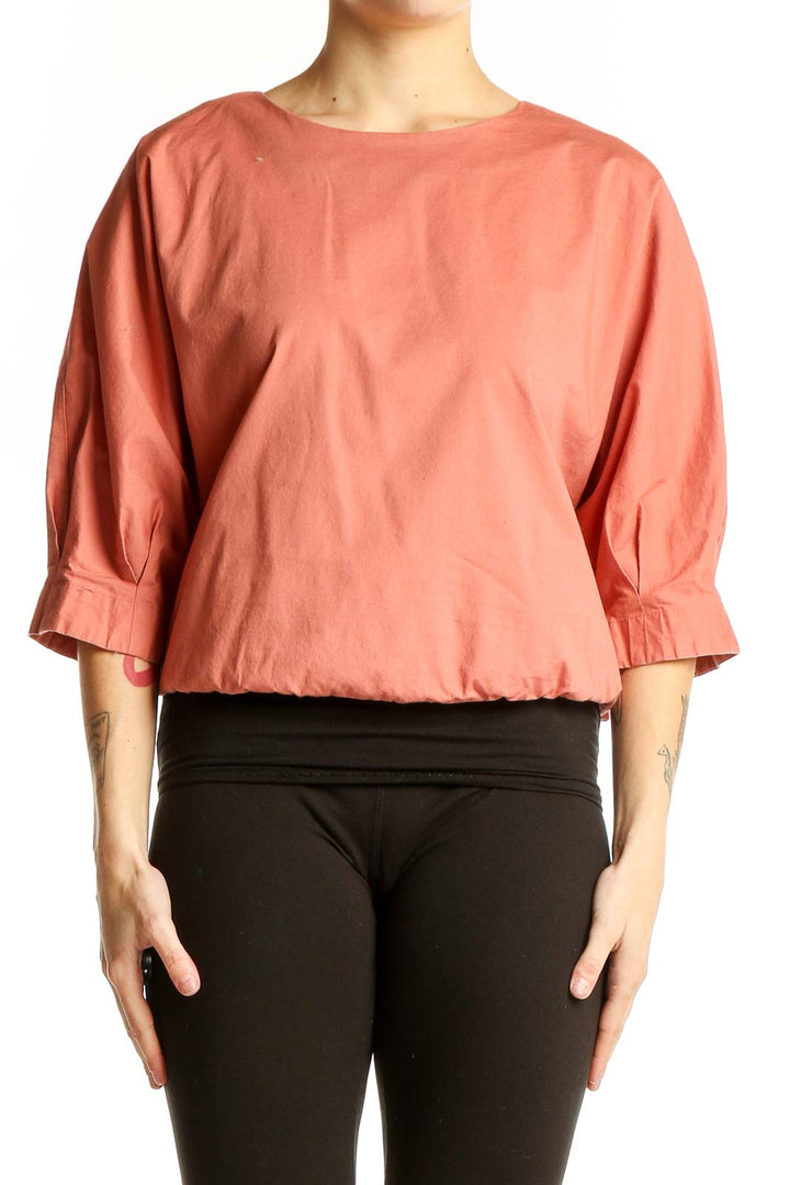Front view of coral Prologue top with puff sleeves