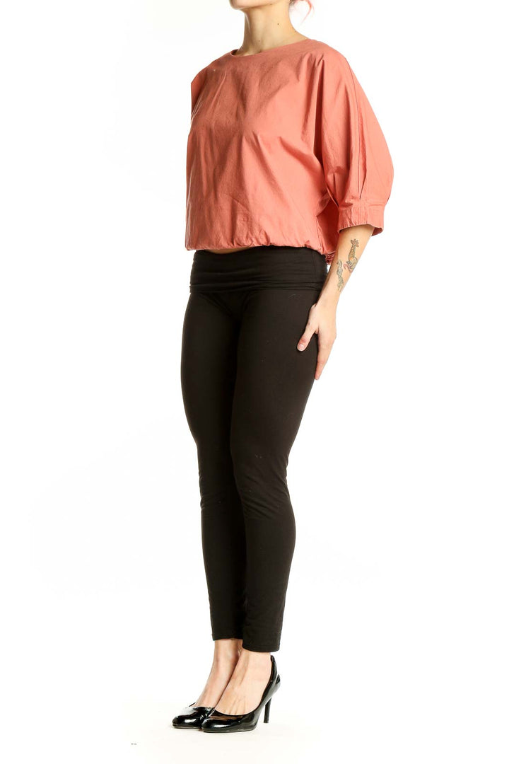 Front view of coral Prologue top with puff sleeves