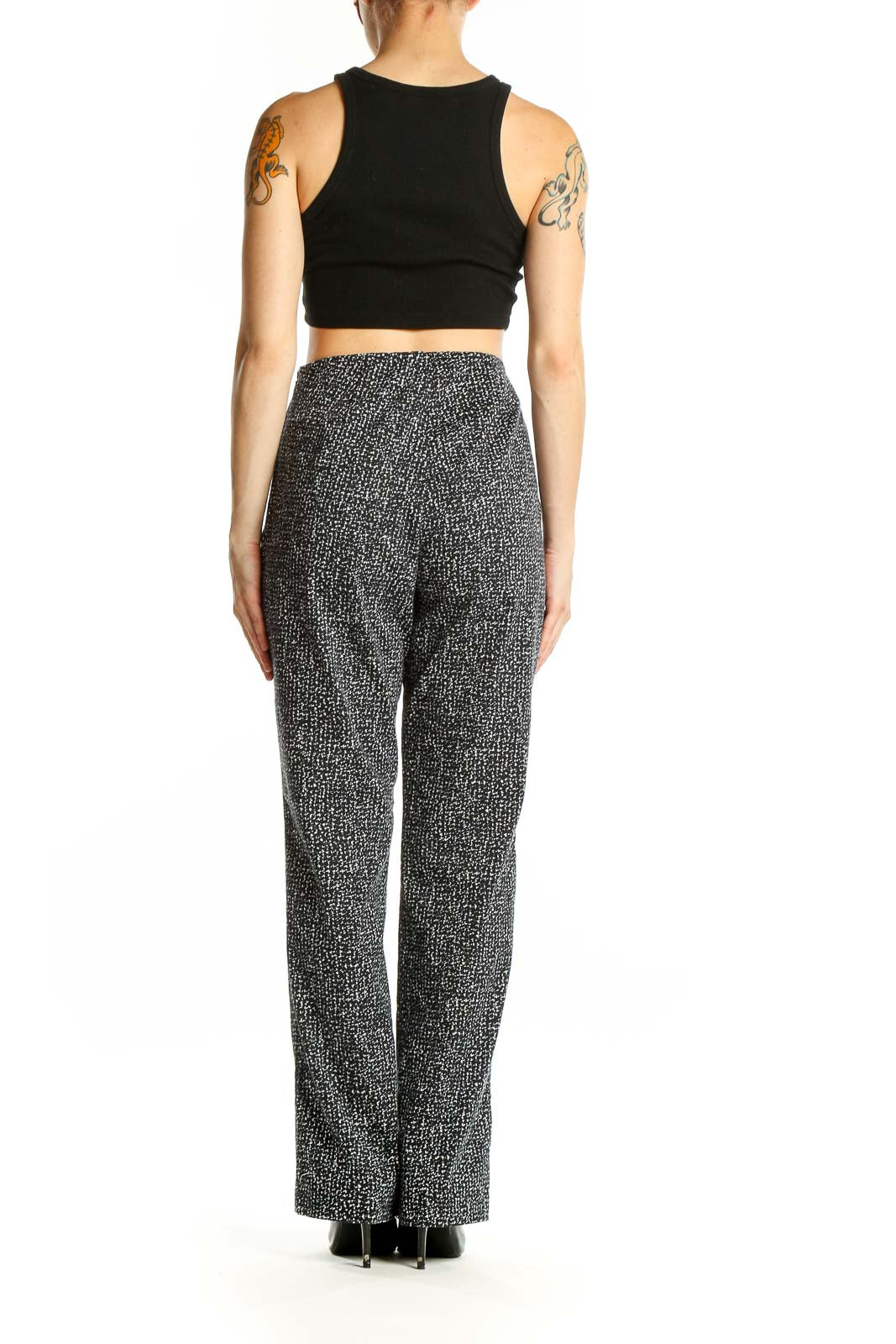 Side view of model wearing Splendid black and white textured wide-leg pants with black crop top