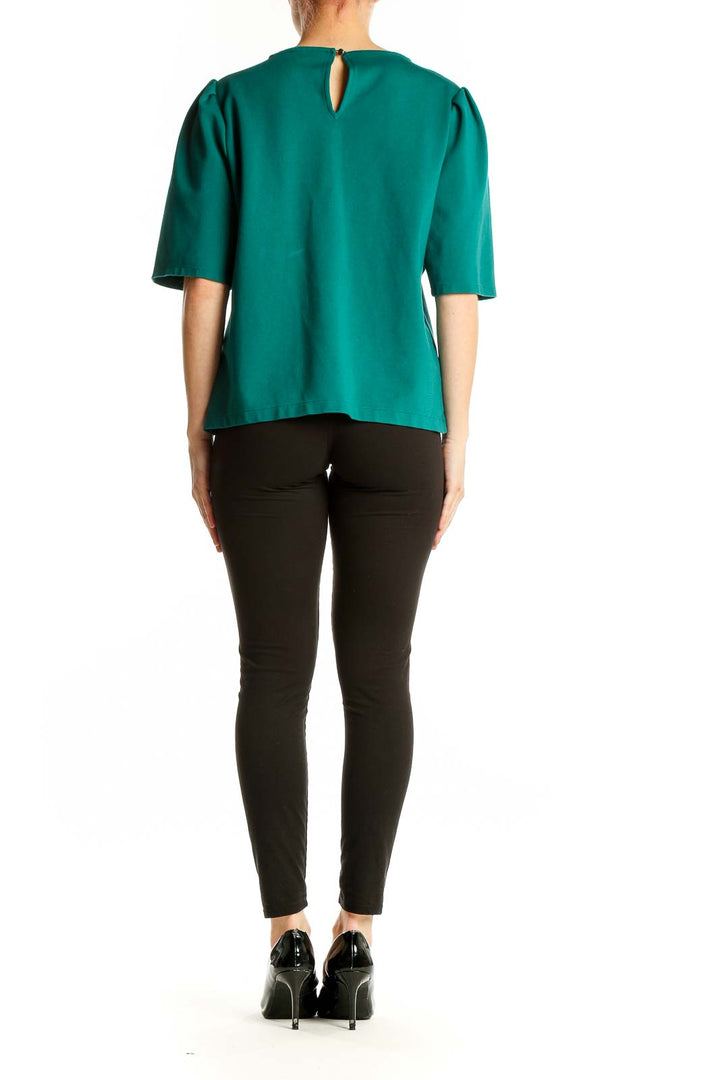 Back view of emerald green J.Crew puff sleeve top on model