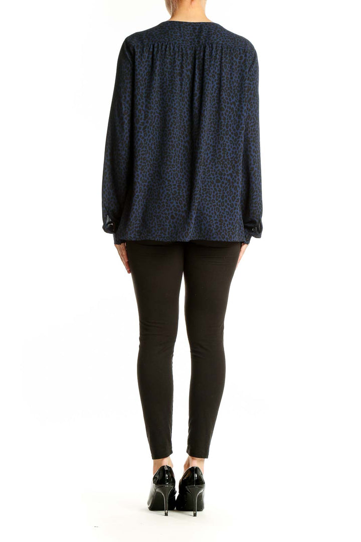 Side view of woman wearing LOFT navy leopard print long sleeve blouse