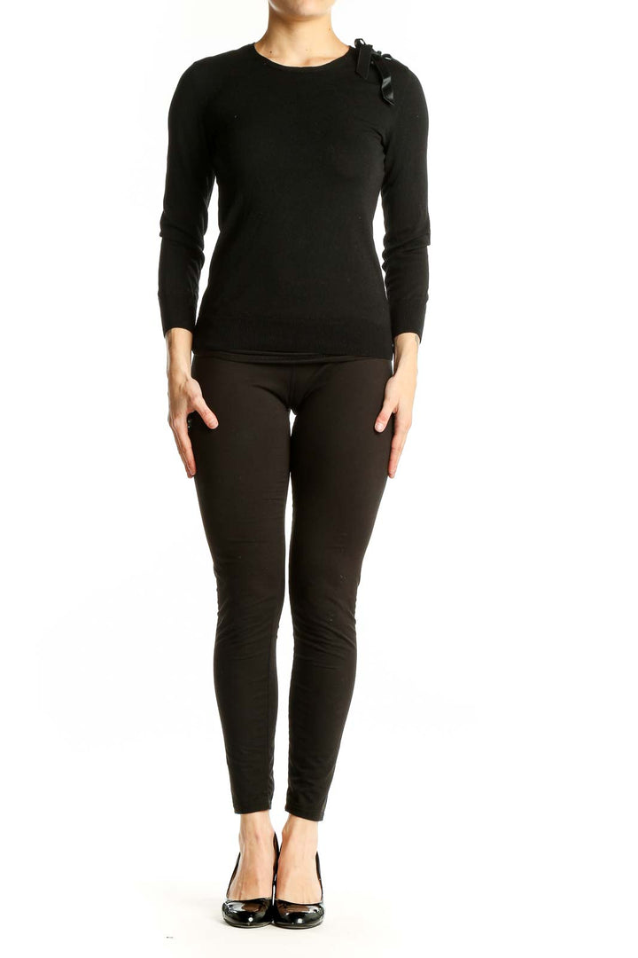 Front view of black Theory sweater with ribbon shoulder detail