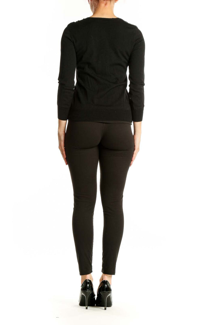 Back view of black Theory sweater showing fitted silhouette