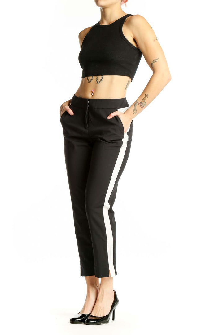 Front view of black cropped trousers with white side stripes