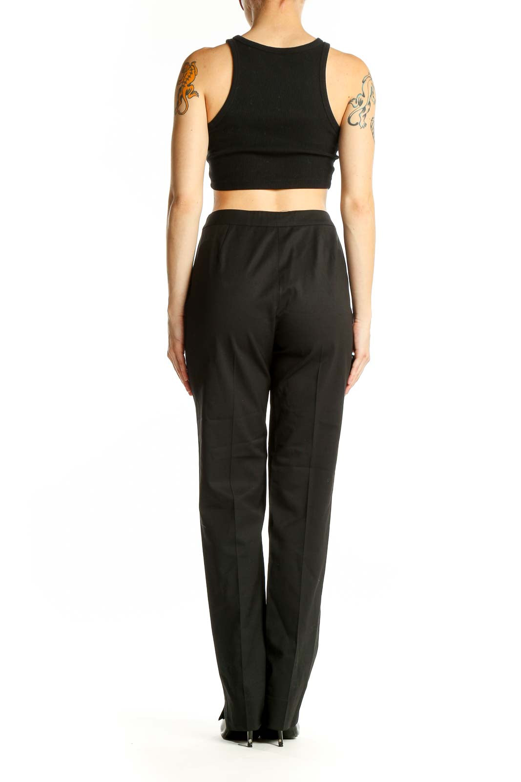 Side view of woman wearing Lafayette 148 New York black straight-leg trousers with matching crop top