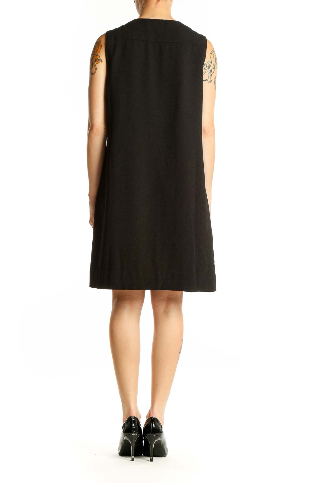 Side view of English Factory black sleeveless shift dress showing relaxed fit