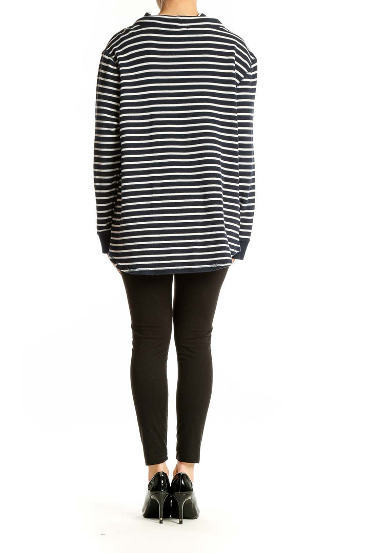 Full body view of model wearing J.Crew navy striped cotton knit sweater with black pants