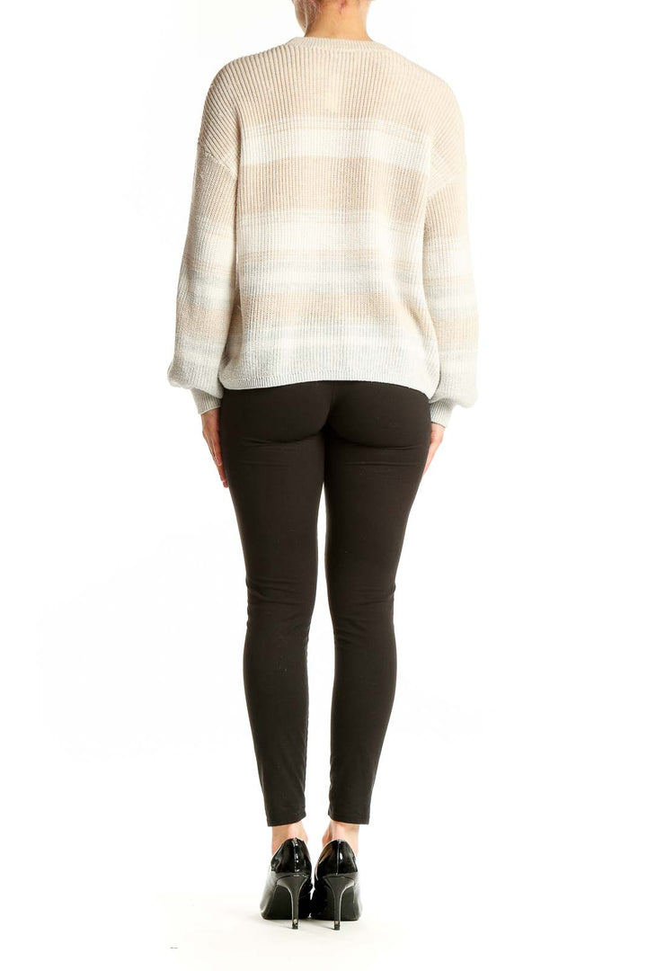 Side view of Gentle Fawn beige striped balloon sleeve sweater on model